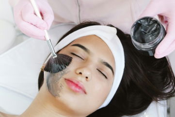 A woman getting her hair cut by a hair stylist